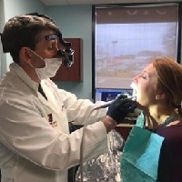 Dentist in Massapequa Park treating patient