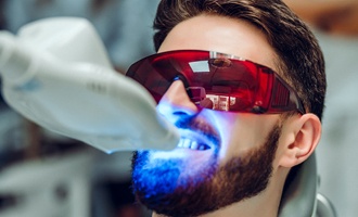 A young man having his teeth whitened in-office