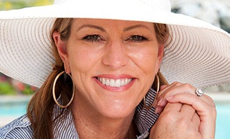 Smiling woman in large sun hat