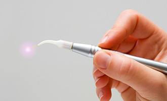 Hand holding dental laser tool