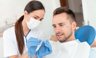 Dentist showing Invisalign to patient