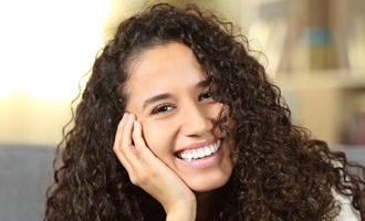 Young woman with healthy teeth smiling at camera