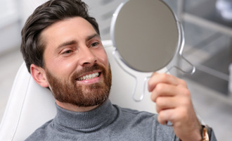 a man smiling in a mirror