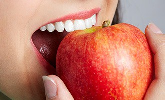 Closeup of person biting into apple