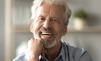 patient smiling after getting dentures in Massapequa Pak