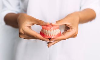 Lady presents viewer with dentures?
