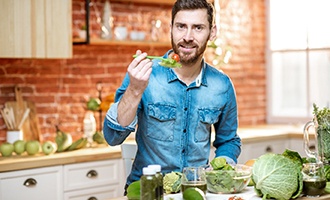 Man eating vegetables and salad in Massapequa Park