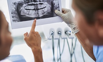 patient and dentist discussing advanced dental implant technology Massapequa Park