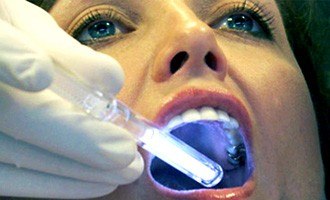 Woman receiving oral cancer screening