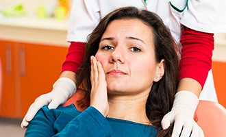 Woman in pain holding cheek