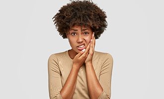 person holding their mouth due to a toothache