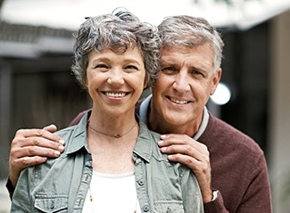 Older man and woman smiling together