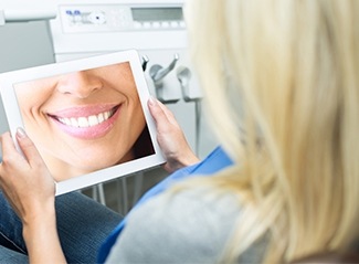 Woman looking at smile design photo