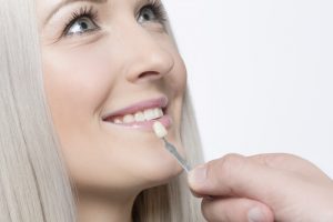 Your Massapequa cosmetic dentist replaces damaged veneers.