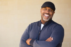 smiling senior man with natural looking dental implants