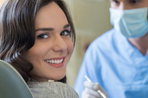 woman with beautiful smile in dental chair