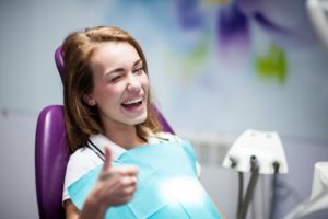 A woman at her dental appointment smiling.