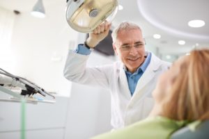 male dentist performing a dental exam on a woman