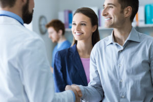 Patient and dentist shaking hands