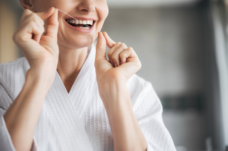 Closeup of female holding dental floss