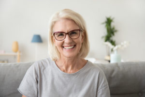 Older woman sitting on couch and smiling