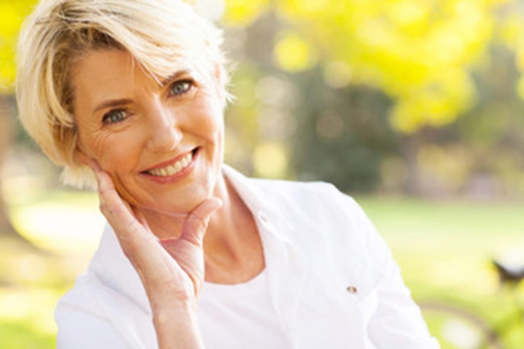 Older woman with dental implants.