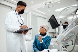 Patient talking with her dentist during a dental implant consultation.