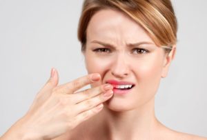 a woman being alarmed by a loose tooth