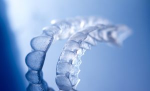Set of clear aligners on blue background