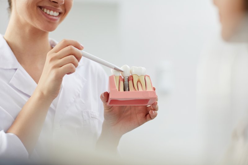 A dentist explaining how dental implants work
