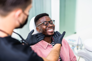 a patient smiling while at his orthodontist's office